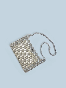 Detail of silver beaded shoulder bag with hexagonal honeycomb weave and gold satin lining
