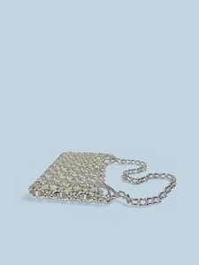 Detail view of the hand-woven silver metal bead mesh bag with a geometric hollow texture