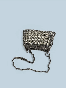 Detail of metal paillette woven handbag with inner pouch and chain shoulder strap