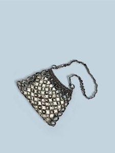 Detail of gunmetal mesh chain handbag with white satin lining and elegant metal strap