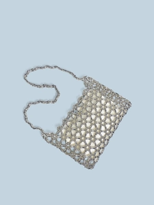 Close-up of a silver beaded shoulder bag with metallic tubes and satin lining