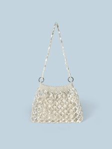 Detail of white beaded mesh handbag showing oval pearl beads and silver metal ring