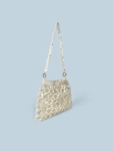 Detailed view of white pearl bead woven handbag with intricate diamond mesh pattern