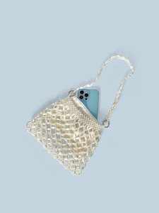Handmade pearl white beaded shoulder bag with satin liner shown on light blue background