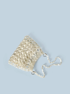 Detail of white beaded woven handbag showing pearl-like texture and satin lining detail