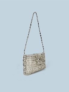 Retro silver metal disc crossbody bag with round sequins and chain strap on blue background