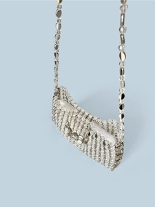Detail view of the silver beaded crossbody bag with sequins and top zipper closure