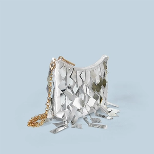 Detail of silver sequin tassel evening bag with metallic chain strap and satin finish