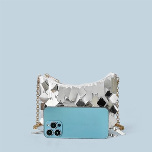 Detailed macro view of silver sequin layers on a vintage style chain shoulder bag