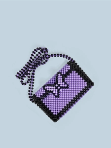 Detail of purple handmade beaded crossbody bag featuring a black beaded butterfly pattern
