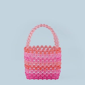 Close-up of vibrant pink and orange gradient beaded weave on a handmade acrylic handbag