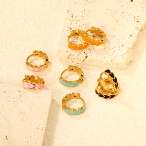 Colorful heart enamel hoop earrings in gold finish set on natural travertine stone