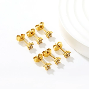 Three pairs of gold star and flower stud earrings with sparkling white crystals