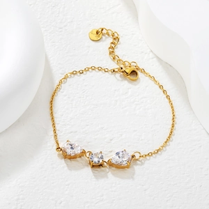 Gold stainless steel bracelet with teardrop crystal charms on artistic white stone base