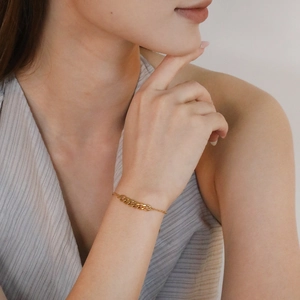 Minimalist 18K gold plated Cuban link chain bracelet for women on a model wrist