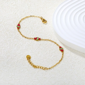 Bracelet en acier inoxydable plaqué or 18 carats avec breloques rayées en forme de bonbon