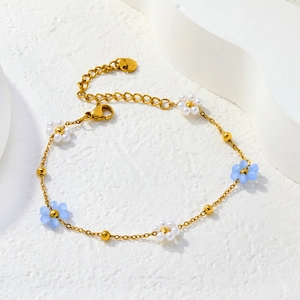 Détail du bracelet doré avec fleurs bleues et fermoir mousqueton réglable pratique
