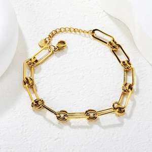 Gold stainless steel industrial link chain bracelet with lobster clasp on white stone
