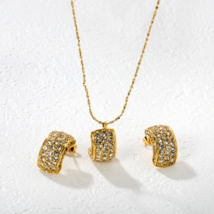 Elegant gold-tone stainless steel jewelry set featuring crystal pavé floral pendant necklace