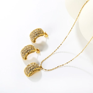 Elegant gold C-shaped jewelry set with micro-pave emerald cut crystals and necklace
