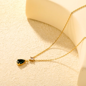 Golden necklace with emerald green pear-shaped pendant and square zircon stone