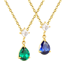 Elegant gold necklaces with emerald green and deep blue teardrop crystal pendants