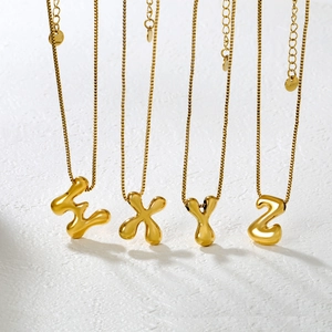 Detailed view of 3D bubble letter pendants E X Y Z on stainless steel box chains