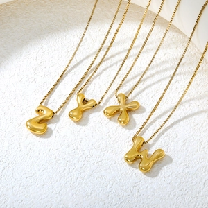 Detailed macro view of 3D bubble initial pendants W X Y Z on gold box chains