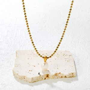 Minimalist gold beaded necklace with a white teardrop pearl pendant for women