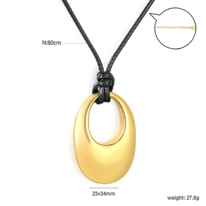 Detailed view of matte gold oval pendant on black wax cord with 60cm chain specifications
