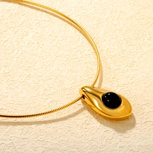 Polished gold water drop pendant necklace with black onyx gemstone in a 45-degree angle view