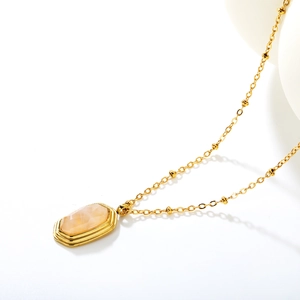 Vintage 18k gold necklace featuring a rectangular amber stone pendant on white background