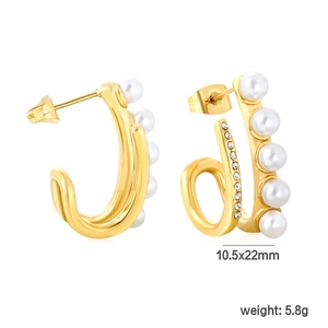 Detail view of gold C-shaped earrings with white pearls and sparkling cubic zirconia