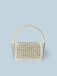Detail of handmade woven pearl evening handbag with sparkling diamond-encrusted accents