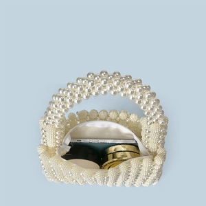 Top view of handmade pearl woven bag showing internal space for phone and makeup items