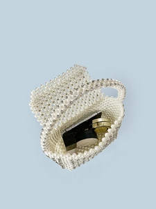 Handmade pearl and rhinestone woven handbag with inner view showing phone storage