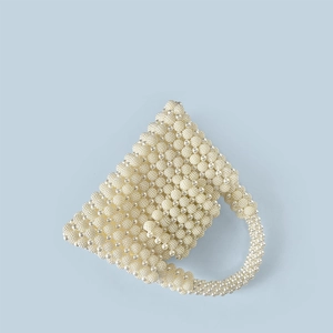 Macro shot of pearl woven handbag showing detailed circular bead structure and texture