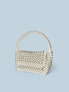 Detail of handmade evening bag with woven pearls and sparkling rhinestones