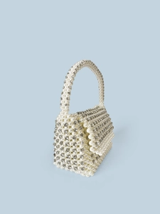 Detailed view of handmade woven faux pearl and rhinestone clutch bag with handle