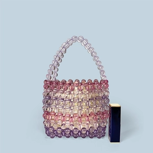 Mini handmade beaded handbag with purple gradient acrylic beads and lipstick for scale