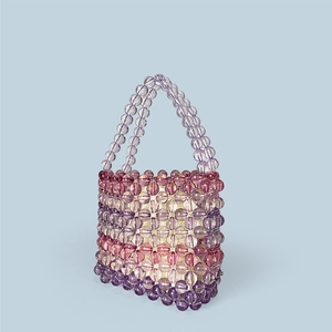 Detail of handmade rainbow beaded bag with clear acrylic beads and soft purple inner pouch