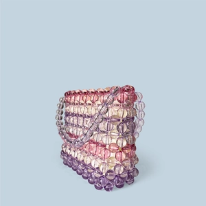 Detail of handmade woven rainbow acrylic beaded handbag with pastel gradient tones