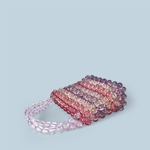 Detail of handmade rainbow beaded bag with transparent acrylic purple and pink beads