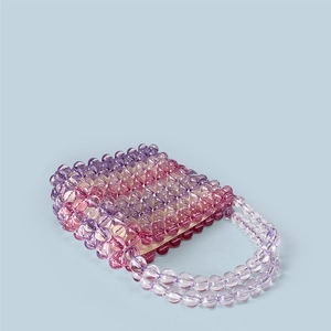 Detail of pink and purple gradient acrylic beaded handbag with woven hollow structure