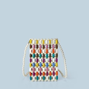 Macro detail of multi-colored wooden beads and white pearl strap on mini crossbody bag