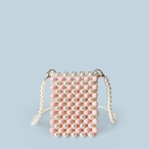 Detail of pink beaded phone bag with white pearl strap and golden lobster clasp