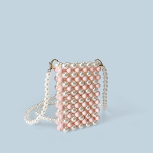 Detail of pink and white handmade pearl woven mini bag with golden metal lobster clasps