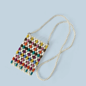 Detail showing colorful beaded crossbody phone bag with artificial pearl shoulder strap