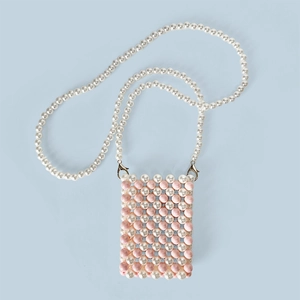 Detail of pink and white handcrafted beaded crossbody bag with pearl strap