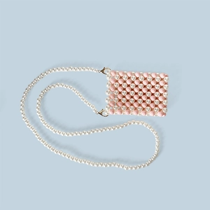 Detailed close-up of pink and white beaded phone bag with golden metal swivel hooks